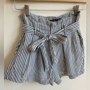 High waisted blue pinstripe paper bag shorts with belt